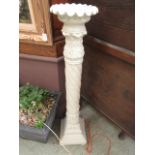 A moulded floor standing candle stand