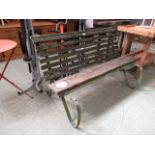 A late 19th century metalwork framed garden bench