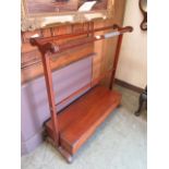 An early 19th century mahogany towel rail with slipper box under