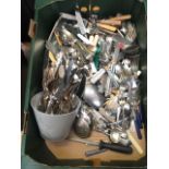 A tray containing a large quantity of flatware