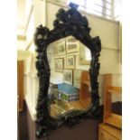 An ornate black painted mirror