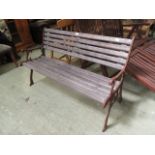 A reproduction metalwork ended garden bench with slatted wood seat