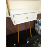 A modern white IKEA style bedside table with single drawer