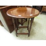 A mid 20th century oak oval top occasional table with barley twist supports