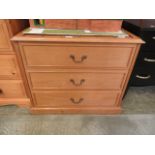 A modern oak effect three drawer chest