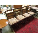 A set of four early 20th century oak framed dining chairs