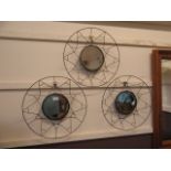 Three metalwork circular wall mirrors