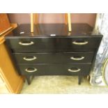 A black painted mid 20th century chest of three long drawers