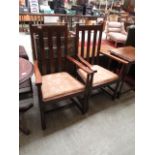 A pair of early 20th century oak framed open arm chairs