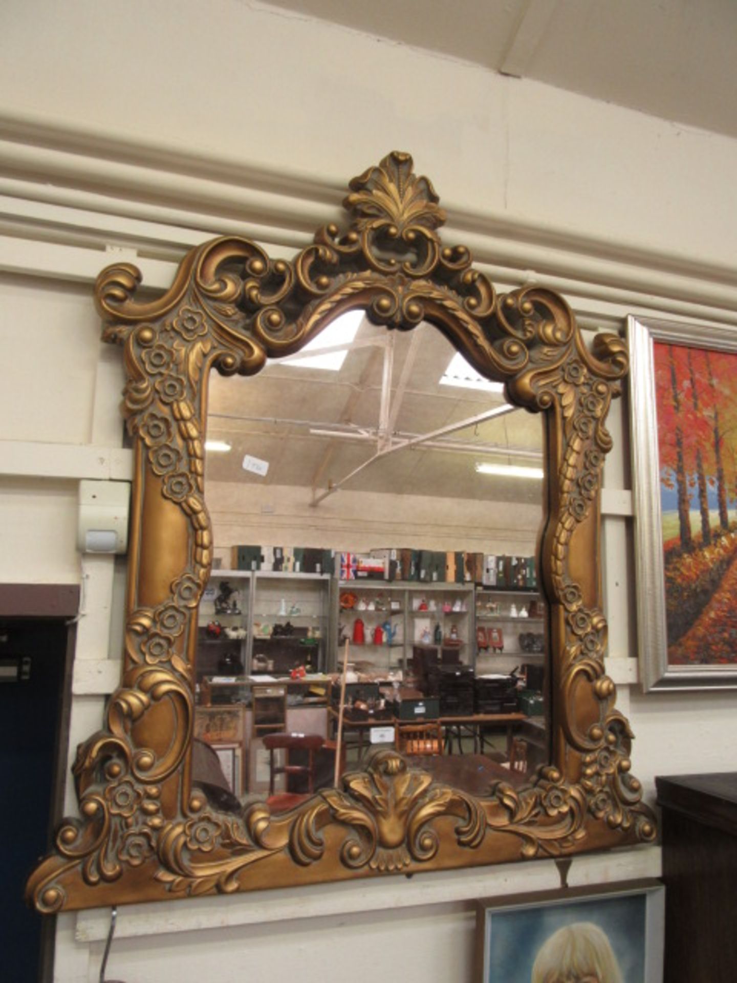 A modern ornate framed over mantle mirror