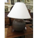 A brass table lamp with shade