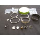 A bag containing a selection of silver and white metal jewellery to include bangles, rings,