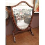 An early 20th century shield toilet mirror