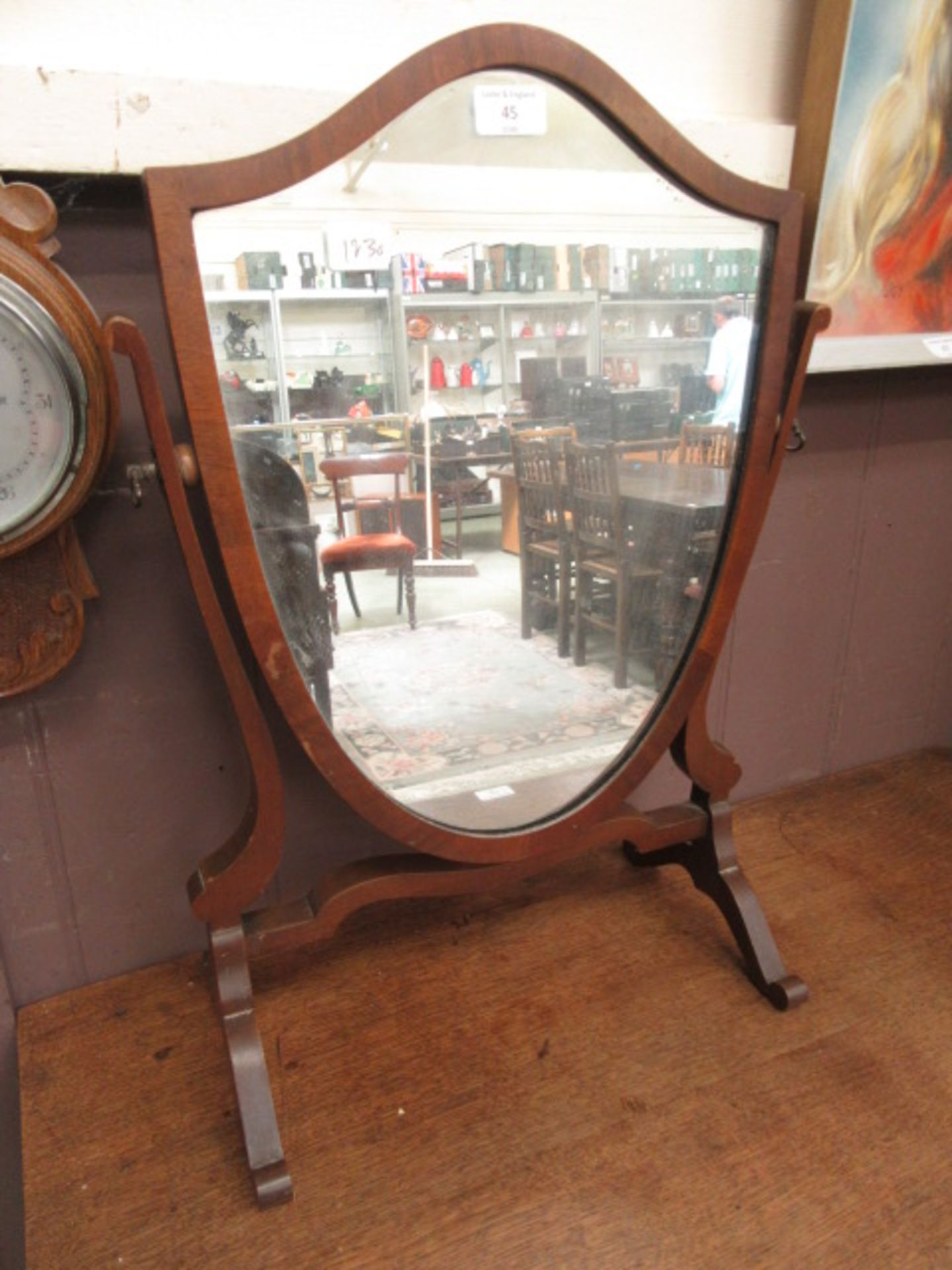 An early 20th century shield toilet mirror