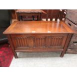 A mid 20th century oak linen fold fronted ottoman