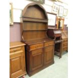 A modern oak Welsh dresser with a dome topped rack over two drawers and two cupboard doors