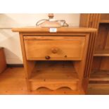 A modern pine bedside cabinet having a single drawer above open storage