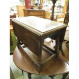 An oak topped drop leaf occasional table