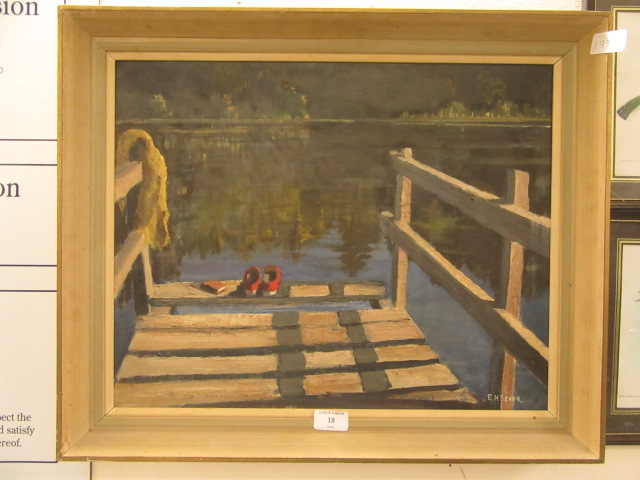 A framed oil on board of lake scene signed E.H.