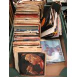 A tray containing a quantity of 45rpm records by various artists