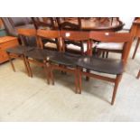 A set of four mid 20th century teak dining chairs