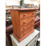 A waxed pine chest of four drawers