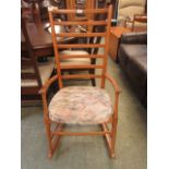 A rail back mid-20th century rocking chair