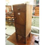 An early 20th century oak cabinet having single drawer over two cupboard doors