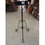 A black painted metal adjustable plant stand