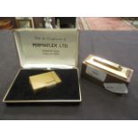 A boxed Zaima lighter number 4039 together with a desk top gilt metal lighter