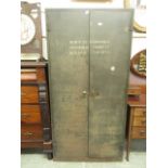 An early 20th century metal two door cabinet bearing the inscription Bury St Edmonds permanent