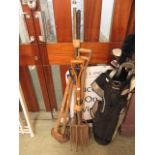 A selection of long handled garden tools