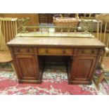 A late 19th century mahogany inlaid twin pedestal desk