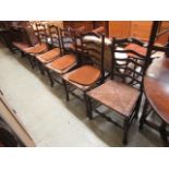 A set of five early 20th century oak framed ladder back dining chairs with seagrass seats