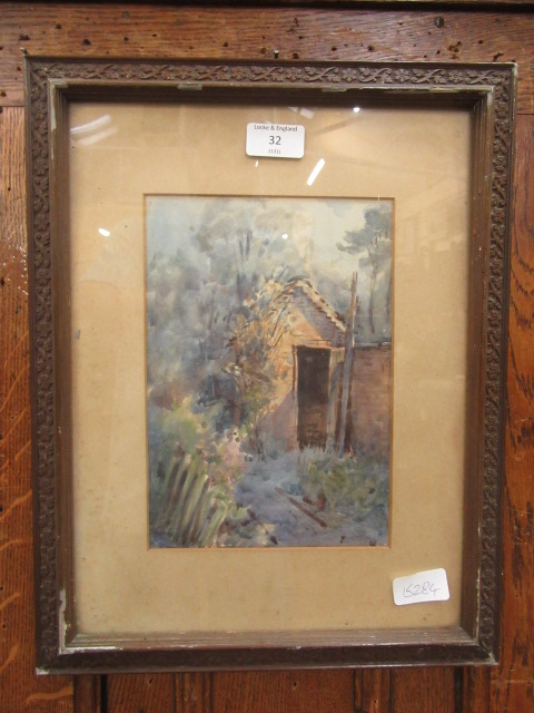 A framed and glazed watercolour of an outhouse