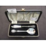 An early 20th century silver hallmarked cake knife and spoon in presentation box, approx.