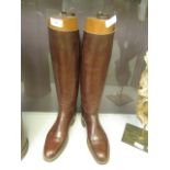 A pair of brown leather riding boots with wooden boot trees CONDITION REPORT: Heel