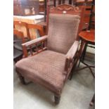 An Edwardian walnut framed open arm parlour chair
