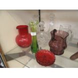 A selection of cut and coloured glass ware to include decanters, pouring jug, cranberry jug etc.