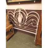 A cream painted metal bedstead