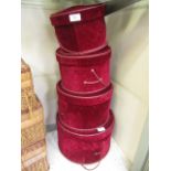 A set of four graduated velvet covered hat boxes