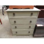 A light green painted chest of four drawers