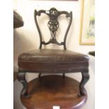 An Edwardian mahogany bedroom chair having carved and pierced top rail on cabriole legs