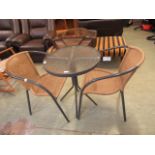 A modern grey metal cicular bistro table with a set of two matching chairs