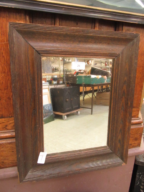 An early 20th century oak framed mirror