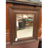 An early 20th century oak framed mirror