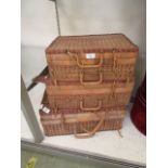 A set of three early 20th century graduated wicker picnic baskets