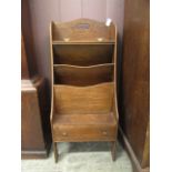 An early 20th century oak magazine rack