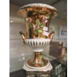 A modern Italian white and gilt floral decorated urn