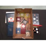 A box containing an assortment of currency to include Britain's first decimal coin set, pennies,